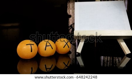 Income Tax and solution. Orange table tennis ball.