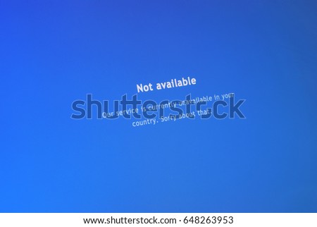 Computer screen shows a message saying the service is unavailable in your country Royalty-Free Stock Photo #648263953