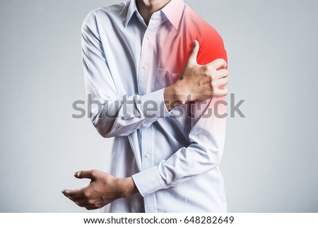 Male holding a shoulder, sick Royalty-Free Stock Photo #648282649
