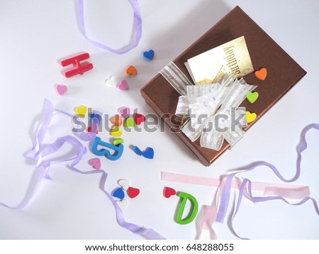 Gift boxes and ribbons and letters on white background