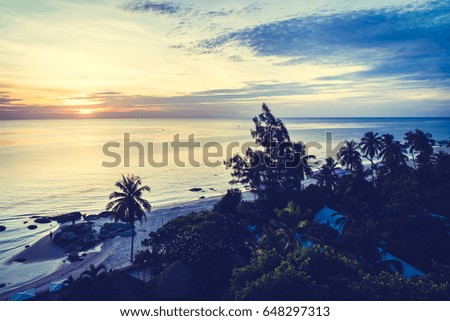 Beautiful Silhouette coconut palm tree with sea and beach at sunrise time - Vintage Filter Processing