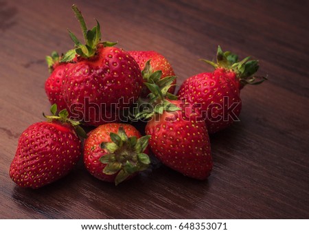 Strawberry with leaves on a brown tree