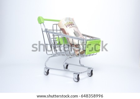 Isolated picture : Mini supermarket cart with Thai banknote one thousand baht.