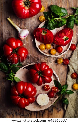 Colorful tomatoes, red tomatoes, yellow tomatoes, and basil. Tomatoes background. vintage wooden background