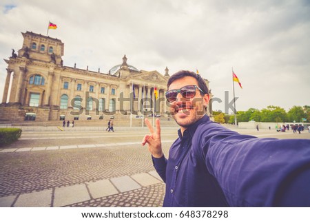 handsome man taking selfie with mobile phone on board of plane - Smiling man having fun flying during the time on the airplane - Concept of happiness on world wide travel
