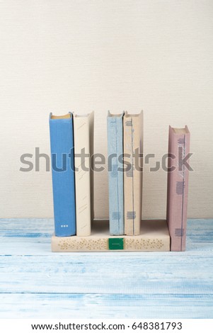 Book stacking, hardback books on wooden table. Back to school. Copy space for text.