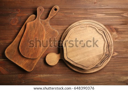 Set of cutting boards on wooden background