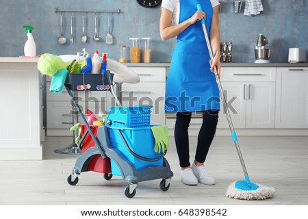 Woman with cleaning tools at home Royalty-Free Stock Photo #648398542