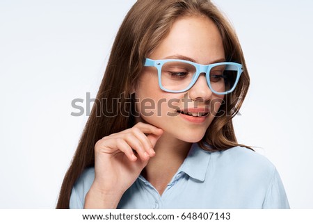 Woman in glasses on a light background portrait                               