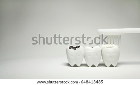 Toothpaste with White Toothbrush on Teeth model in happy emotion and Decayed tooth, if brush the teeth, teeth will good healthy
