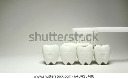 Toothpaste with White Toothbrush on Tooth model in happy emotion, if brush the teeth, teeth will good healthy