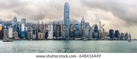 Panoramic view of the towers of Hong Kong under a stormy sky