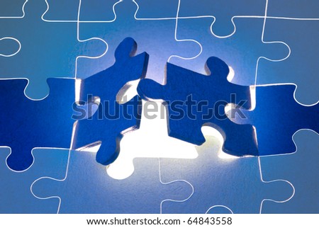 Dark blue puzzles.  It is a metaphor (the beginning; opening; end). Royalty-Free Stock Photo #64843558