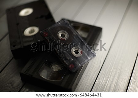 Vintage music and video cassettes on a gray background