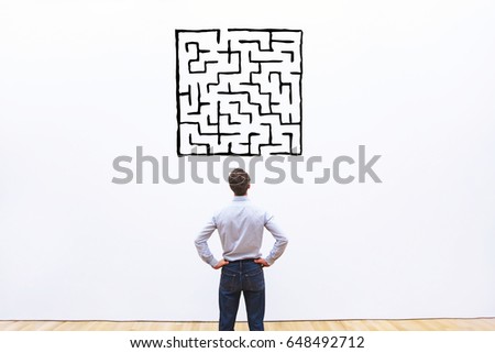 business man looking at labyrinth drawing, complicated difficult solution concept Royalty-Free Stock Photo #648492712