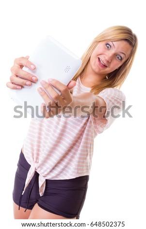 Modern devices, social media, photography concept. Blonde woman taking self picture, selfie, with tablet. Studio shot isolated
