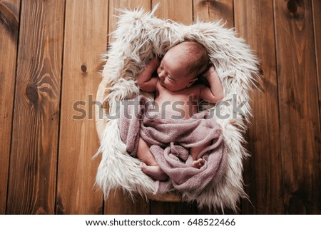 Newborn sleeping in a basket