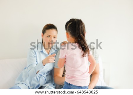 Daughter is be scolding by her parents Royalty-Free Stock Photo #648543025