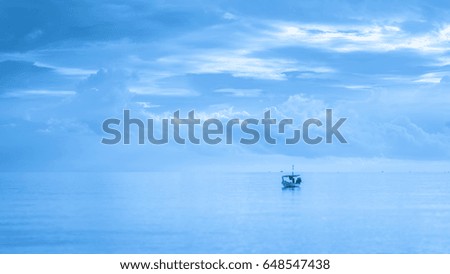 Mono chrome picture : One boat stop distant from the beach with cloud : seascape