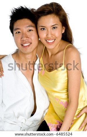 A young man and young woman in nightwear hugging each other