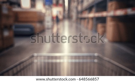 Blur image of front part shopping cart move foward in warehouse or sale floor area, effected by vintage or classic style.