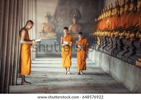 Novice monks reading book inside monastery at Ayutthaya province, Thailand