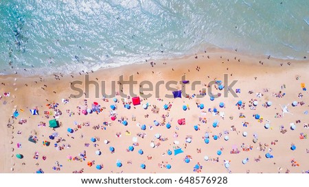 Tropical beach with colorful umbrellas - Top down aerial view Royalty-Free Stock Photo #648576928