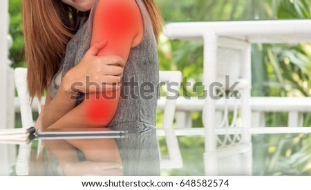 Asian business woman Acute pain in arm , shoulder pain expression in office ,Health care in office concept