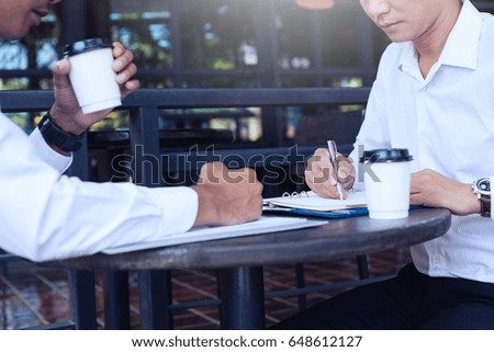 businessman working on negotiation to sign contract with partners at coffee cafe
