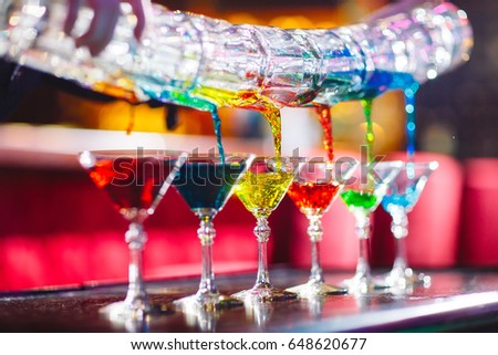 Barman show. Bartender pours alcoholic cocktails. Royalty-Free Stock Photo #648620677