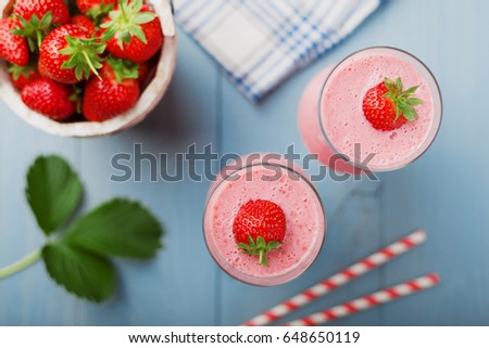 Delicious strawberry smoothie with milk, prepared with fresh strawberries. Served in elegant glasses.