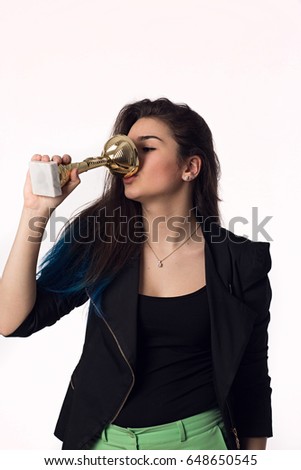 Beautiful brunette student girl in black jacket with goblet