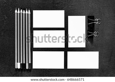 Business cards and stationery on a black background of stone table texture. Layout for branding. Sample for corporate identity. Template for graphic designers of presentations and portfolio.Top view