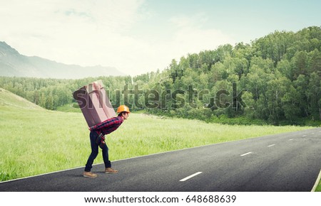Man carrying on his back large box