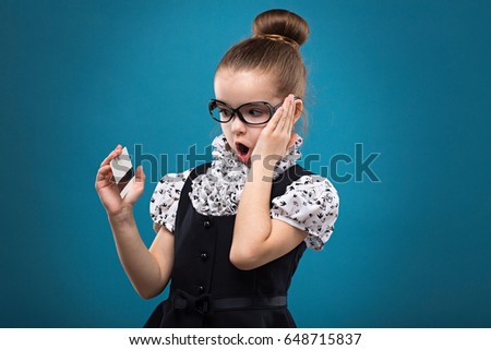 Little dark hair child with credit card dressed like teacher in black dress