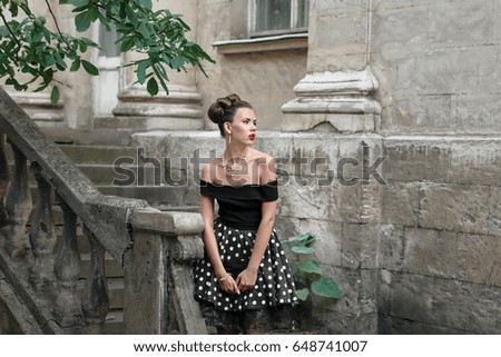 beautiful girl in the retro style posing outdoors