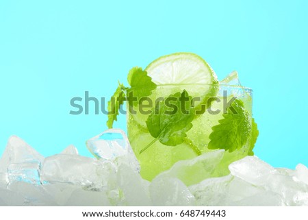 A glass of lemonade with lime and mint