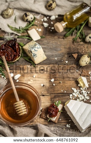 Different types of cheese on wooden background ,composition, delicatessen ,concept and gourmet cheeses