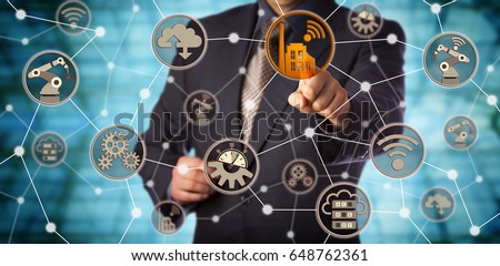 Blue chip manufacturer touching smart factory icon in a virtual machine to machine network. Concept for industry 4.0, computerization of manufacturing, cyber-physical systems and interoperability. Royalty-Free Stock Photo #648762361