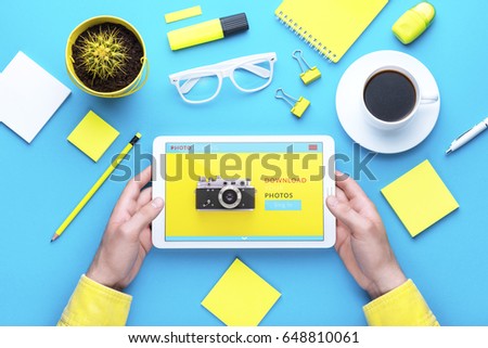 Man holding tablet in hand. Digital technology. Innovative implementation in business. Internet applications. Tablet phone and camera. Developing applications on the Internet. Flat lay photo
