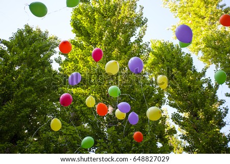 Air colorful balloons in the Park summer flying in the sky, feast on a Sunny day