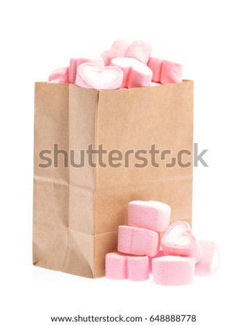 brown bag with sweet heart shape of marshmallow isolated on white background.