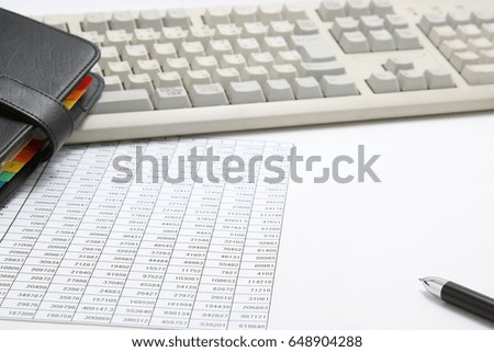 
Business concept. 
Business document, personal organizer, and pen with computer keyboard.
Workplace for the business person.