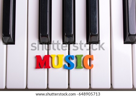 Word music from color letters. Piano keys close-up music