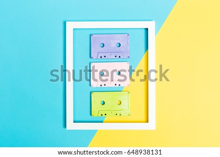 Retro cassette tapes and frame on bright duotone background
