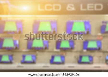 blurry of a shop selling household appliances and LED LCD TVs was blurred for use as a background,vintage color smart television