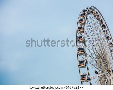 Vintage Retro Ferris Wheel Over Blue Sky in Bangkok,Thailand