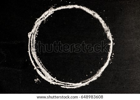 Chalk drawing as circle shape as blank stamp or seal on blackboard background