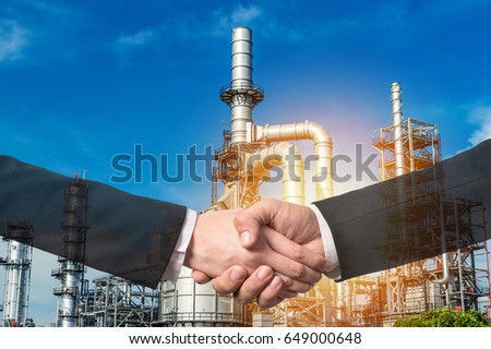 bussiness concept hand shake on Oil Refinery factory Petroleum background