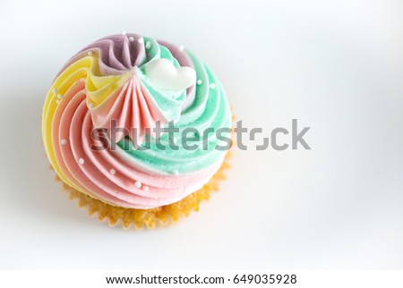 Top view Birthday cupcake on white Background.mini cake. cupcake with rainbow cream and heart for love valentines.image for background,wallpaper and copy space.
